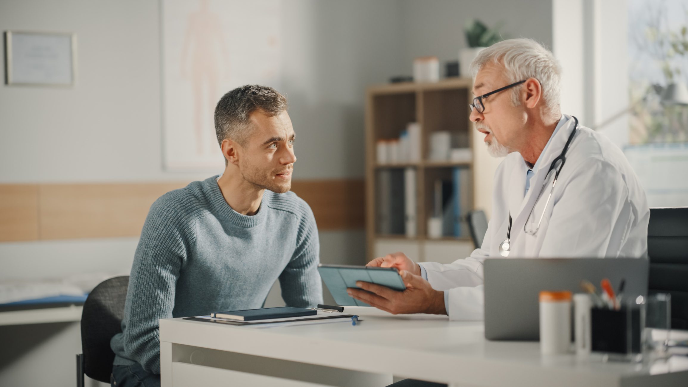 Doctor consulting patient in a medical office.