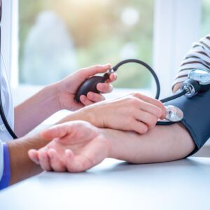 Blood pressure being measured by healthcare professional.