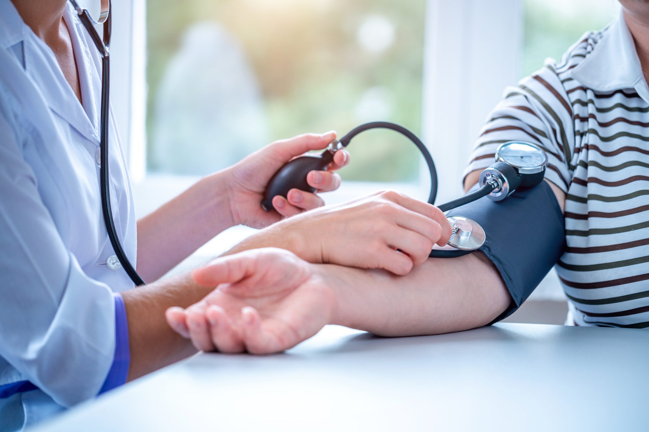 Blood pressure being measured by healthcare professional.