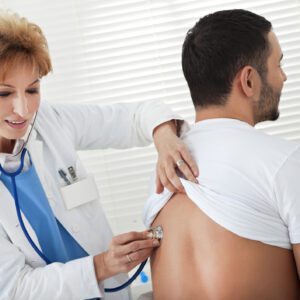 Doctor examining patient's back with stethoscope.