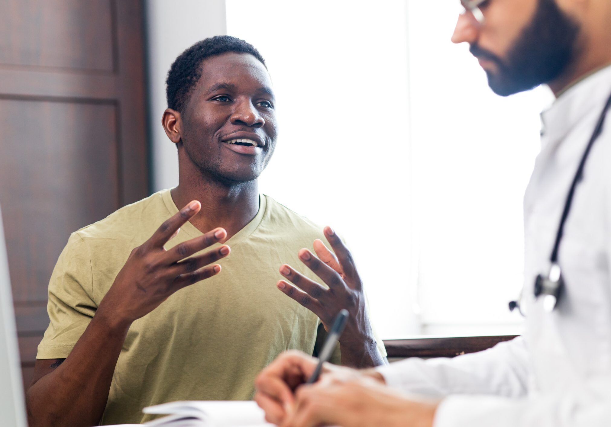 Patient discussing with a doctor in office.